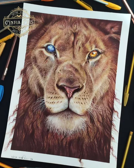 Realistic drawing of a lion with one blue eye and one amber eye, made in ballpoint pen